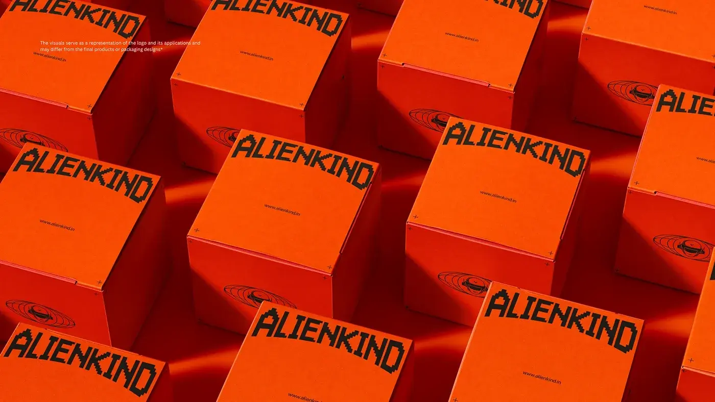 ALIENKIND branded orange shipping boxes with pixel wordmark by StudioDraft